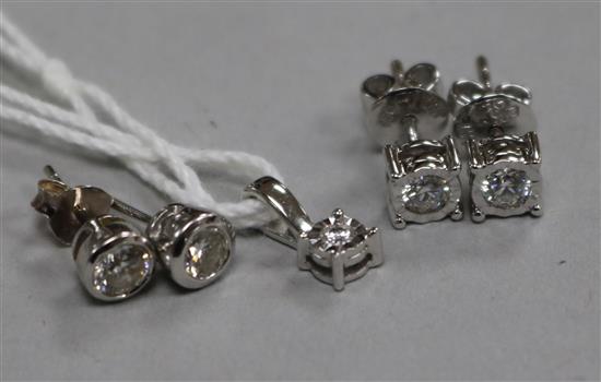 Two pairs of white gold and diamond ear studs (one 18ct, one 14ct) and an 18ct white gold and diamond pendant.